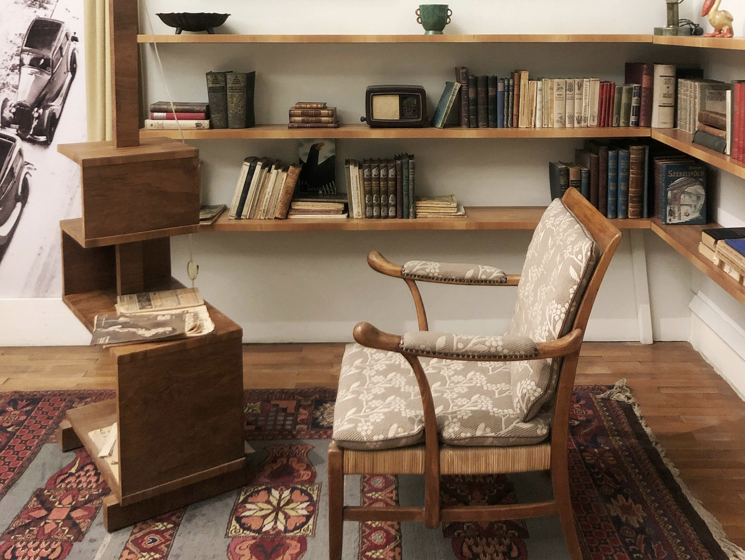 A simple console styled with books, pottery and greenery